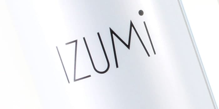 IZUMI Caressing and awakening massage oil product label graphics.
