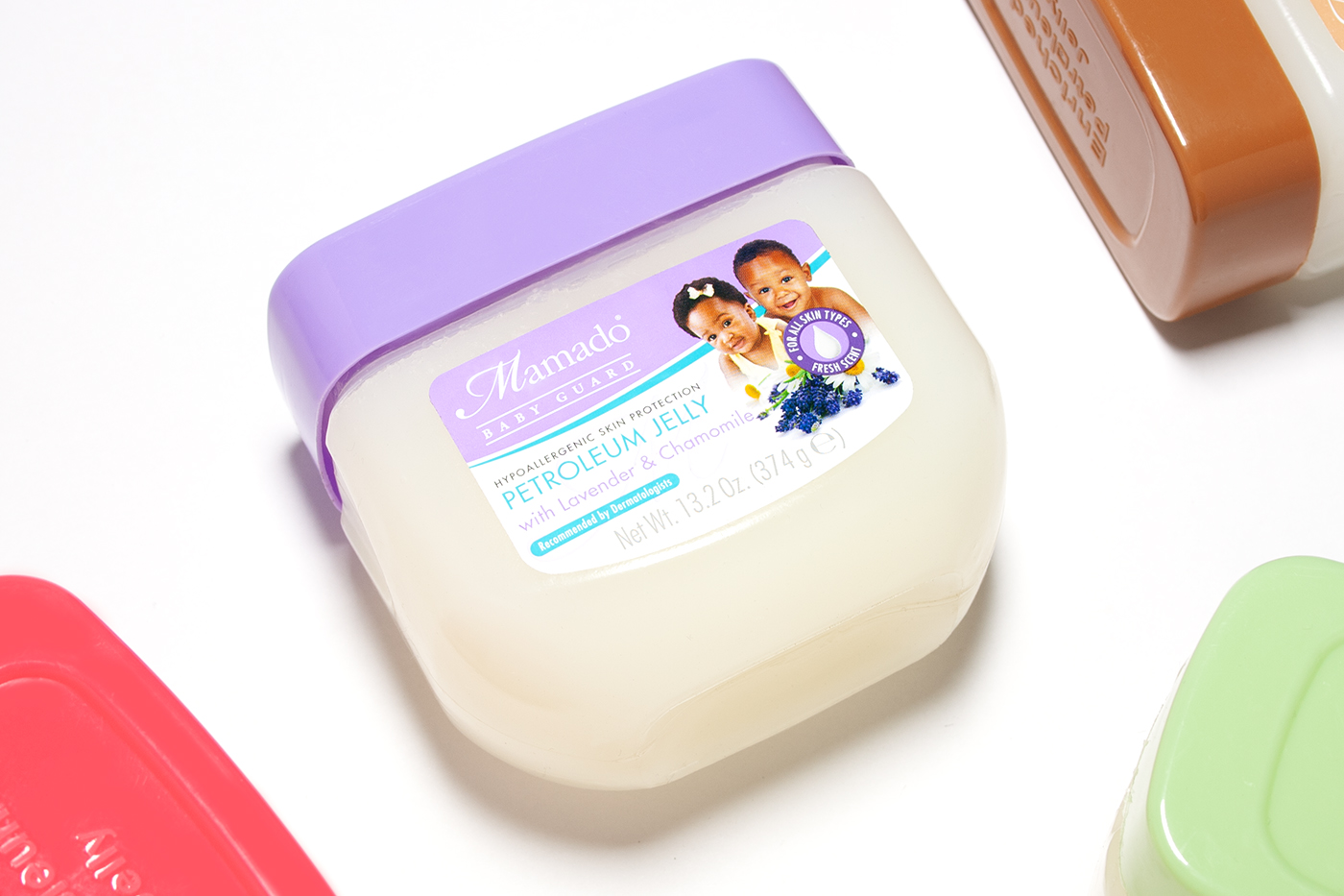 Close-up of Lavender & Chamomile petroleum jelly product featuring baby care label identity design graphics by Paul Cartwright Branding.